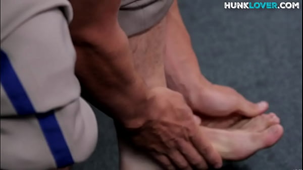 Solo stud teases body while stroking dick in locker room